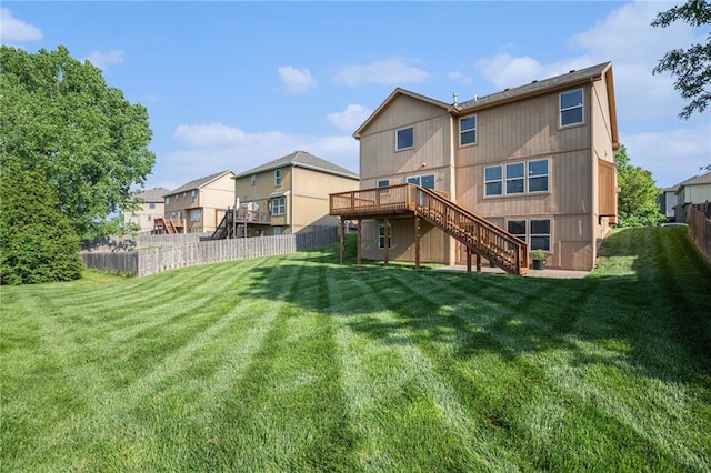 back of house featuring stairway, a deck, and a residential view