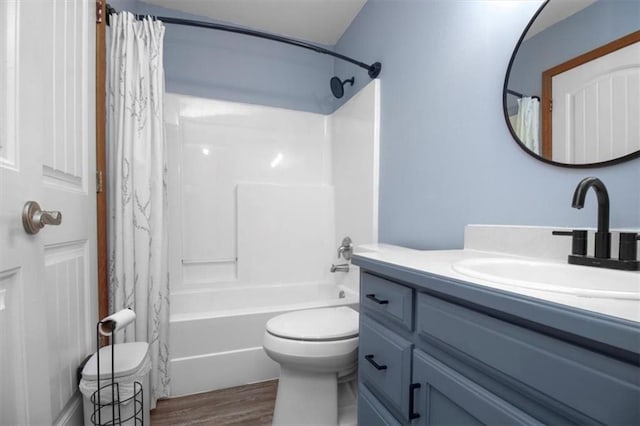 full bath with vanity, wood finished floors, shower / tub combo with curtain, and toilet
