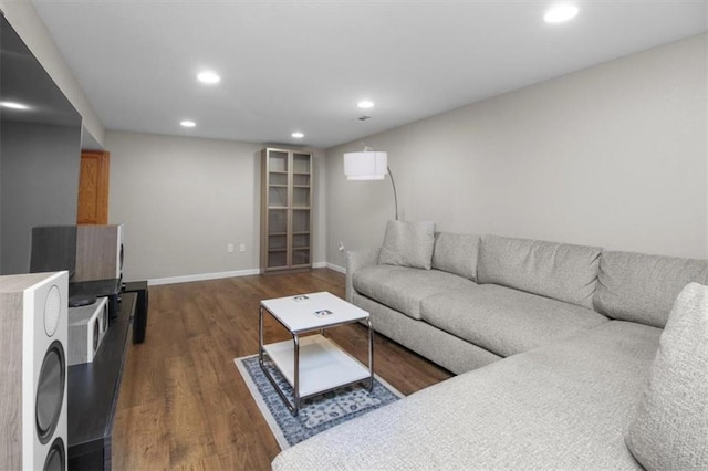 living area featuring dark wood-style floors, recessed lighting, and baseboards