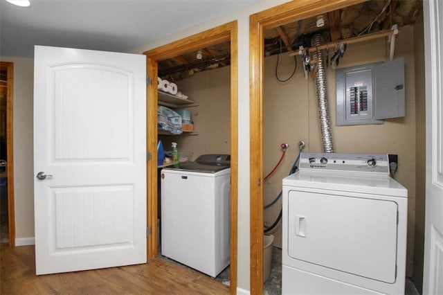 laundry area with electric panel, independent washer and dryer, and wood finished floors
