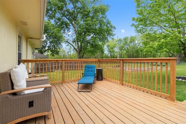 wooden terrace featuring a lawn