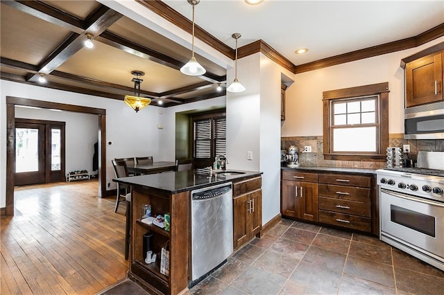 108 W 61st Ter, Kansas City, MO 64113 - kitchen with appliances with stainless steel finishes, tasteful backsplash, a sink, open shelves, and a peninsula