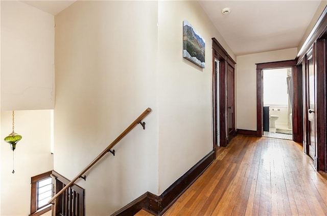 108 W 61st Ter, Kansas City, MO 64113 - hallway with an upstairs landing, wood-type flooring, and baseboards