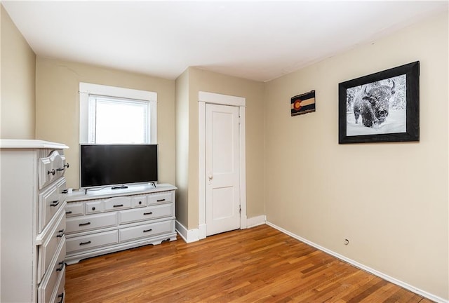 108 W 61st Ter, Kansas City, MO 64113 - unfurnished bedroom with baseboards and light wood finished floors