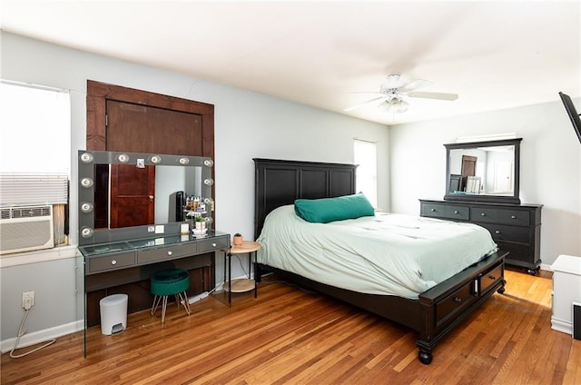 108 W 61st Ter, Kansas City, MO 64113 - bedroom with wood finished floors, cooling unit, a ceiling fan, and baseboards