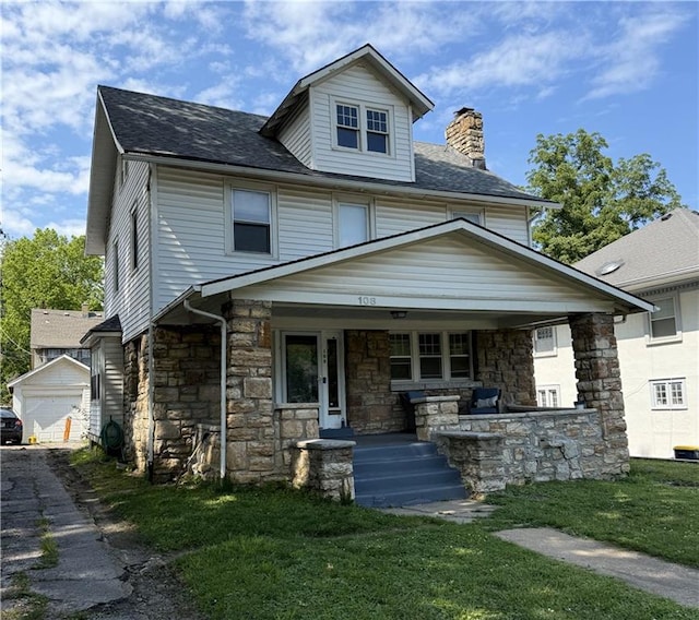 108 W 61st Ter, Kansas City, MO 64113 - traditional style home featuring a chimney, covered porch, stone siding, a front yard, and a shingled roof
