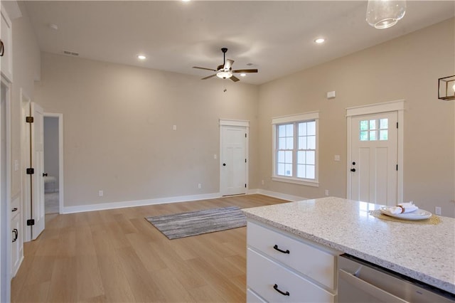 kitchen featuring a ceiling fan, light wood-style flooring, stainless steel dishwasher, white cabinets, and recessed lighting