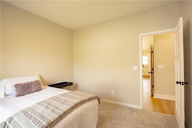 bedroom with carpet flooring and baseboards
