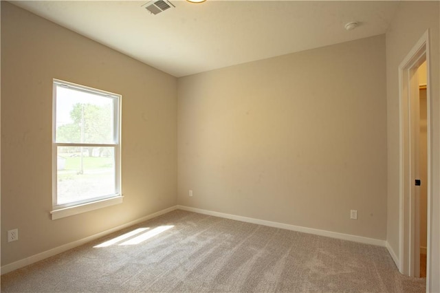 unfurnished room with light carpet, a smoke detector, and baseboards
