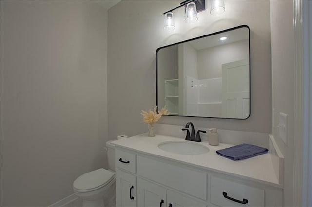 bathroom featuring vanity, toilet, and baseboards