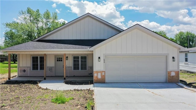 606 E 3rd St, Cameron, MO 64429 - view of front of property with a shingled roof, a garage, driveway, and board and batten siding