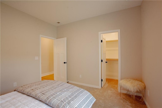 606 E 3rd St, Cameron, MO 64429 - bedroom featuring light colored carpet, a spacious closet, baseboards, and a closet