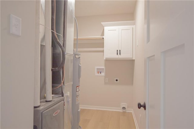 606 E 3rd St, Cameron, MO 64429 - laundry room featuring hookup for an electric dryer, cabinet space, light wood finished floors, washer hookup, and baseboards