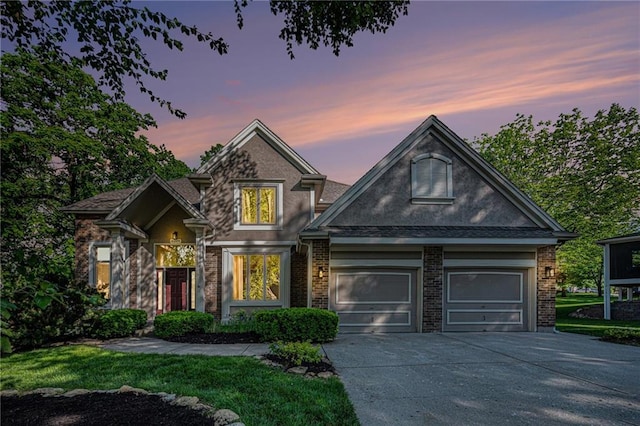6209 NW 78th St, Kansas City, MO 64151 - view of front facade with driveway, stucco siding, brick siding, and a garage