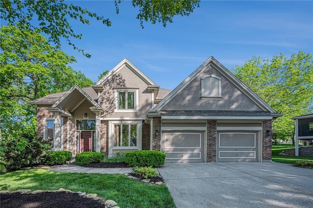 6209 NW 78th St, Kansas City, MO 64151 - view of front of house with stucco siding, driveway, brick siding, and an attached garage
