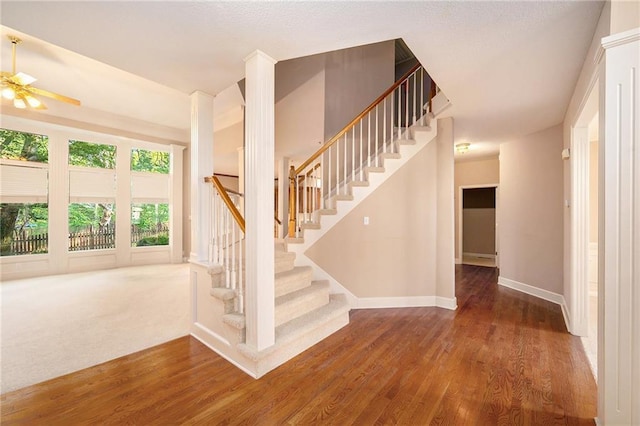 6209 NW 78th St, Kansas City, MO 64151 - staircase with wood finished floors, ceiling fan, and baseboards
