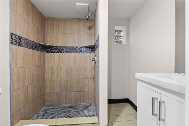 3107 N 34th St, Kansas City, KS 66104 - bathroom featuring tiled shower, tile patterned flooring, vanity, and baseboards