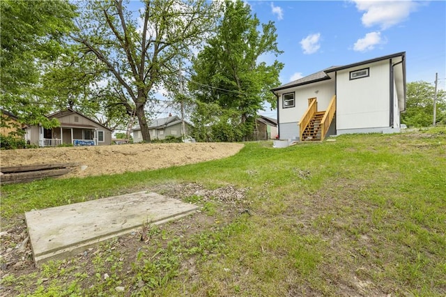 3107 N 34th St, Kansas City, KS 66104 - back of house featuring stairs and a lawn