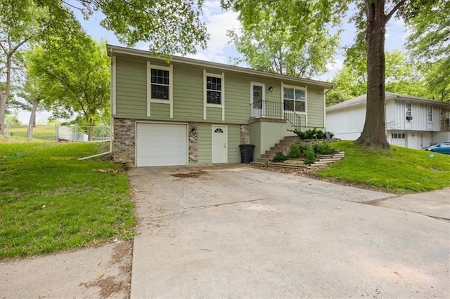 808 SE 19th St, Oak Grove, MO 64075 - view of front of house with a front lawn, brick siding, an attached garage, driveway, and stairway