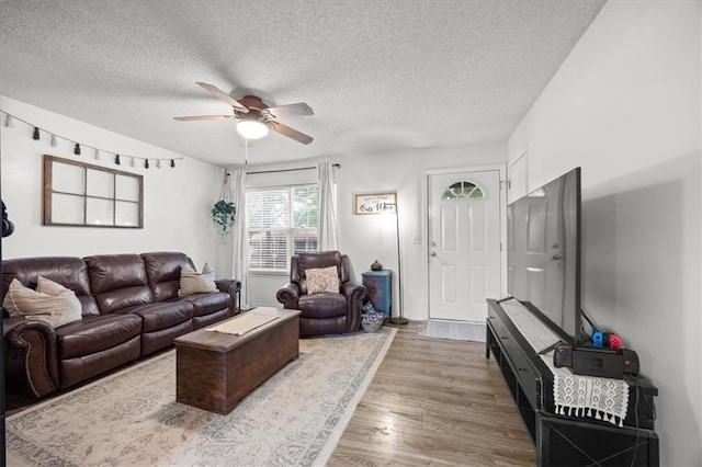 808 SE 19th St, Oak Grove, MO 64075 - living area with ceiling fan, a textured ceiling, and wood finished floors