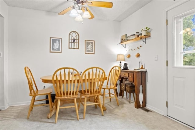 808 SE 19th St, Oak Grove, MO 64075 - dining area with healthy amount of natural light, a textured ceiling, ceiling fan, and baseboards