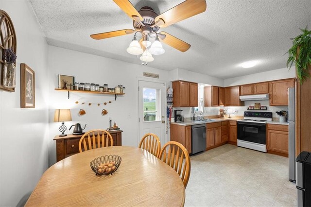 808 SE 19th St, Oak Grove, MO 64075 - kitchen featuring electric range, dishwashing machine, under cabinet range hood, a textured ceiling, and light countertops