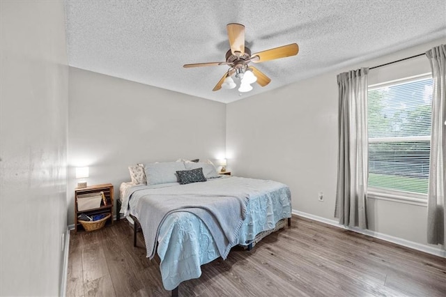 808 SE 19th St, Oak Grove, MO 64075 - bedroom with wood finished floors, a textured ceiling, baseboards, and ceiling fan