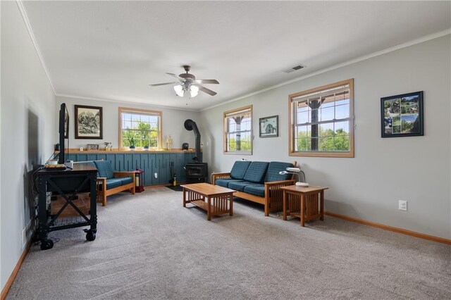 9 SW 500th Rd, Warrensburg, MO 64093 - sitting room with a wood stove, carpet, ornamental molding, baseboards, and a ceiling fan