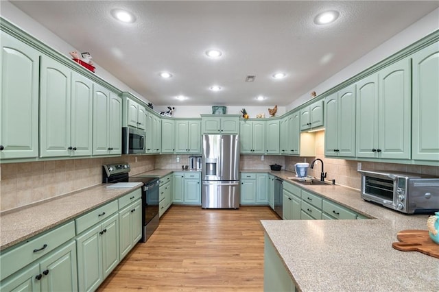 9 SW 500th Rd, Warrensburg, MO 64093 - kitchen featuring stainless steel appliances, a sink, decorative backsplash, green cabinets, and recessed lighting