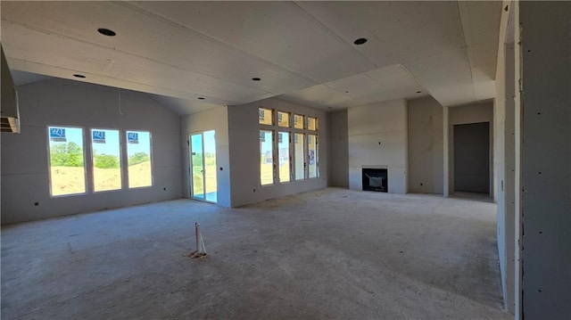 unfurnished living room featuring a fireplace and vaulted ceiling
