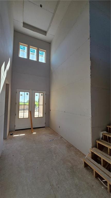 unfurnished room with a towering ceiling