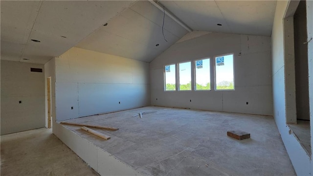spare room with lofted ceiling