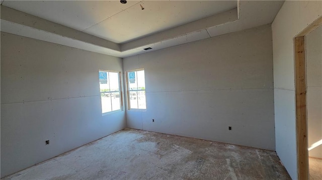 spare room featuring a raised ceiling