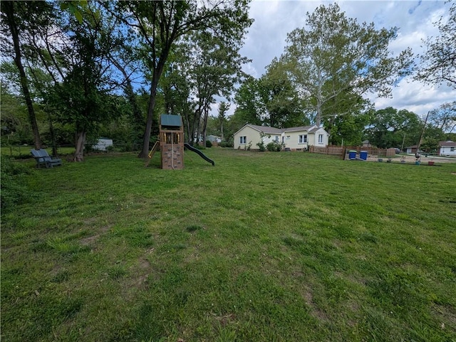 view of grassy yard featuring a playground