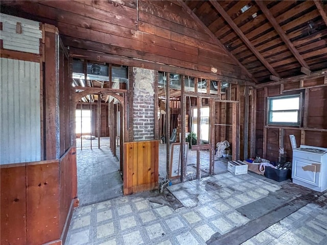 misc room with wood walls, vaulted ceiling, and wood ceiling