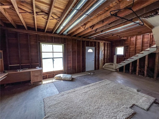 miscellaneous room featuring stairs and wood finished floors