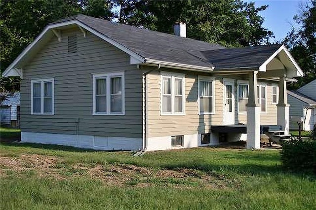2011 S Broadway St, Pittsburg, KS 66762 - view of property exterior featuring a chimney and a yard