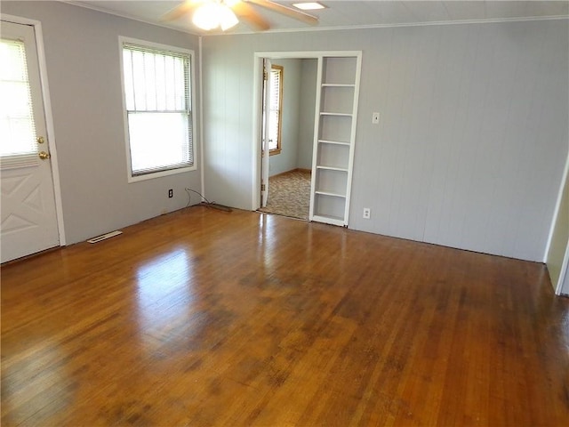 2011 S Broadway St, Pittsburg, KS 66762 - unfurnished bedroom with wood finished floors, ornamental molding, and ceiling fan