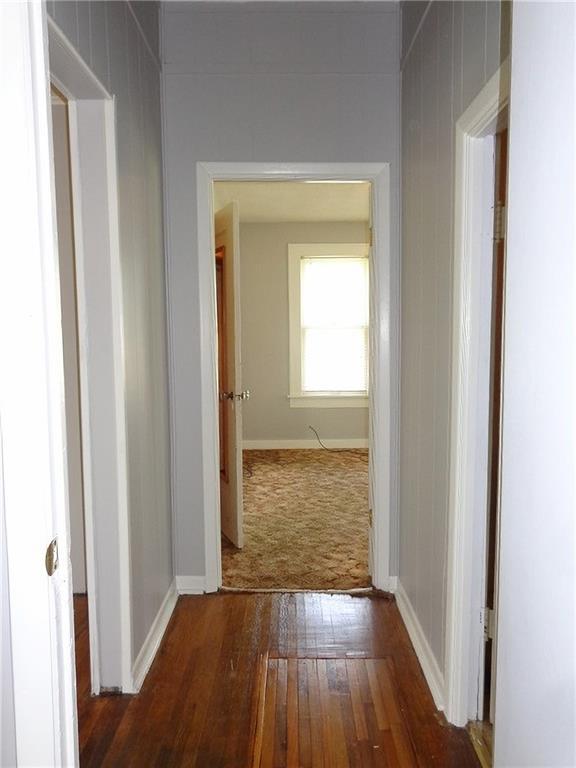 2011 S Broadway St, Pittsburg, KS 66762 - hallway featuring hardwood / wood-style flooring and baseboards