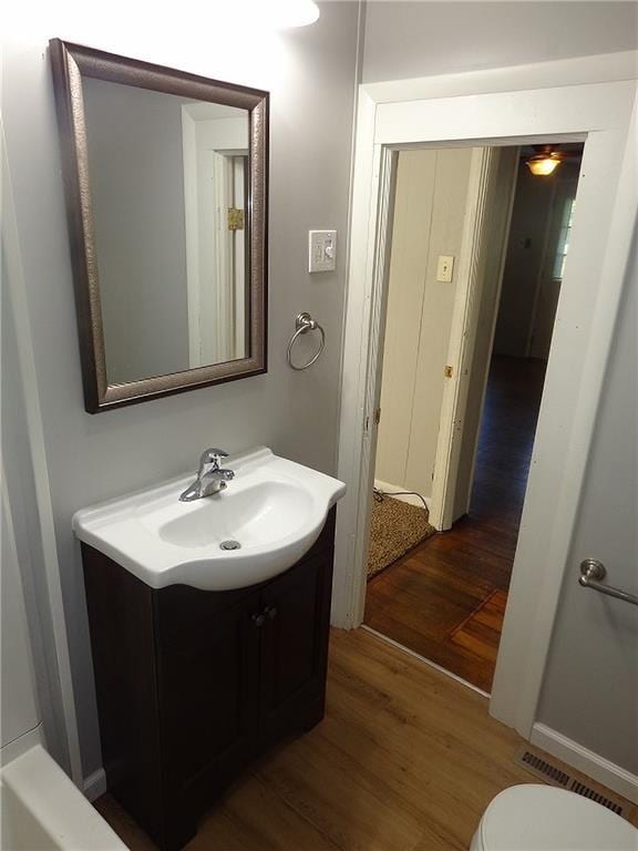 2011 S Broadway St, Pittsburg, KS 66762 - bathroom with wood finished floors, vanity, and toilet