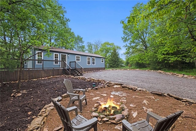 13 S Lakeside Cir, Linn Valley, KS 66040 - back of property with an outdoor fire pit and a wooden deck