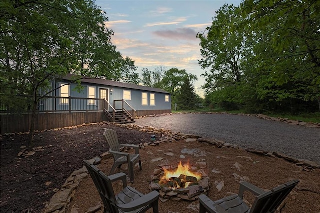 13 S Lakeside Cir, Linn Valley, KS 66040 - back of property featuring a fire pit and driveway