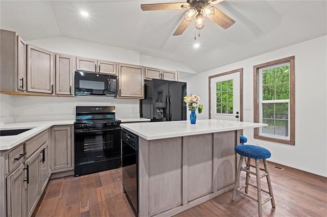 13 S Lakeside Cir, Linn Valley, KS 66040 - kitchen with black appliances, lofted ceiling, dark wood-style flooring, light countertops, and a center island