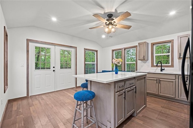 13 S Lakeside Cir, Linn Valley, KS 66040 - kitchen with lofted ceiling, a sink, a breakfast bar, hardwood / wood-style flooring, and french doors