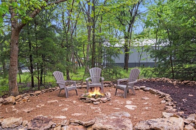 13 S Lakeside Cir, Linn Valley, KS 66040 - view of yard featuring an outdoor fire pit