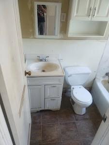 bathroom with vanity, toilet, a bath, and a shower