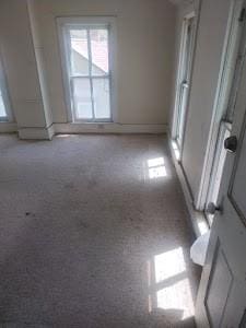 unfurnished room featuring baseboards