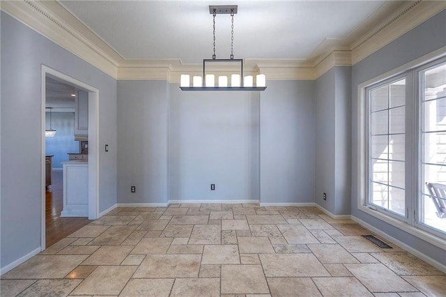 unfurnished room featuring ornamental molding, light stone finish flooring, and baseboards