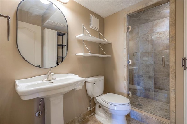 full bathroom featuring a shower stall, toilet, baseboards, and a textured ceiling