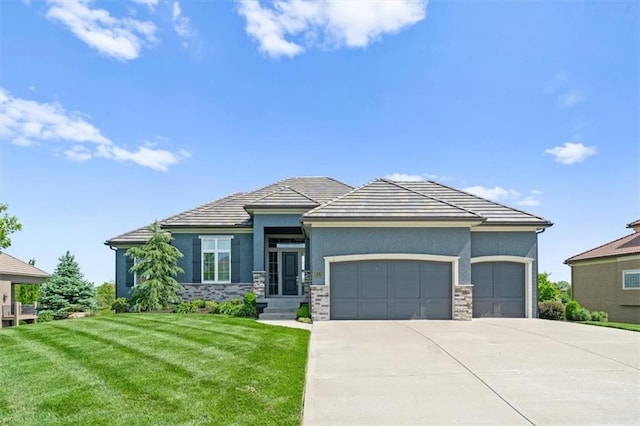 10523 N Dalton Ave, Kansas City, MO 64154 - prairie-style house featuring an attached garage, concrete driveway, a front yard, stucco siding, and stone siding